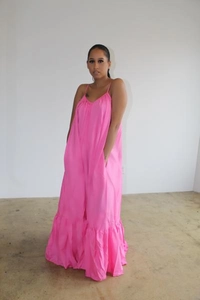 Detailed view of pink V-neck sleeveless maxi dress with ruffle hem and side pockets