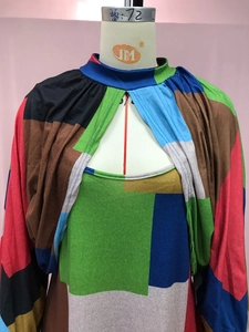 Detailed view of long sleeve patchwork dress with high neck and teardrop cutout detail