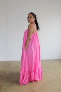 Detail view of hot pink sleeveless maxi dress with thin straps and ruffled hem design