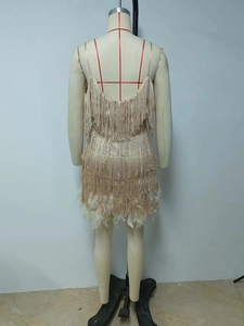 Detailed back view of champagne sequin fringe dress with white feather trim and V-neckline