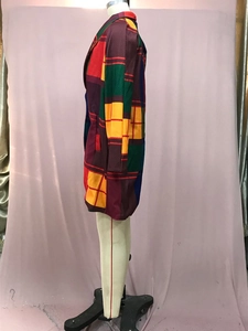 Detailed side view of colorful color-block plaid blazer coat with notched lapels and pockets