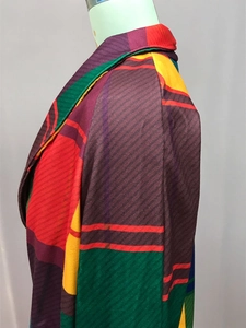 Detail of geometric color block wool coat collar and shoulder seam with vibrant patterns