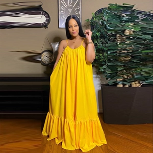 Detail view of a yellow summer maxi dress with thin straps and ruffled hem design