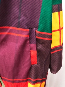 Detailed close-up of side pocket on multi-color patchwork plaid coat for women