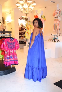 Detail of blue summer maxi dress featuring thin straps and tiered ruffle hemline