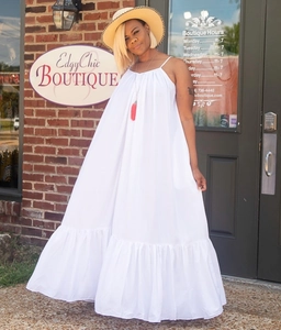 Detail view of white halter maxi dress with ruffle hem and loose fit for summer
