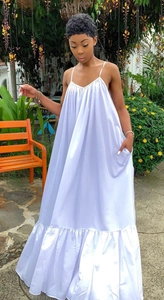 Detailed view of white silk texture maxi dress with spaghetti straps and ruffled hemline