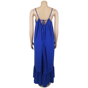 Detail of dark blue backless maxi dress featuring thin straps and ruffled hemline