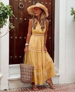 Detail of yellow V-neck chiffon dress with lace embroidery and gold polka dots