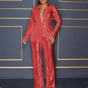 Detailed view of red sequin fabric texture on a long-sleeve blazer and wide-leg trousers