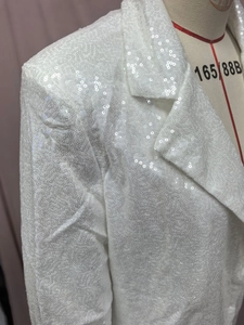 Close-up of white sequin blazer with slim fit cut and notched lapel on a mannequin