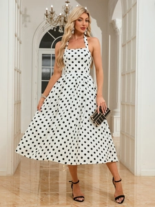 Elegant sleeveless halter neck polka dot midi dress with A-line silhouette for summer