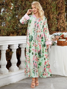 Floral print bohemian maxi dress in mint green with long sleeves and pink accents
