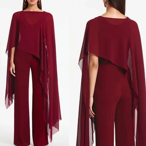 Detail of burgundy chiffon cape with wide-leg trousers showing drape and fabric texture