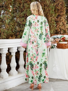 Detail of floral print on light green maxi dress with pink satin cuffs shown from the back
