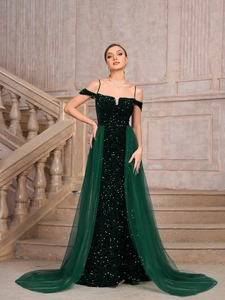 Detail of sequins and tulle on an elegant dark green floor-length evening gown with train