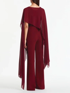 Elegant wine red jumpsuit with sheer chiffon cape shown from the back perspective