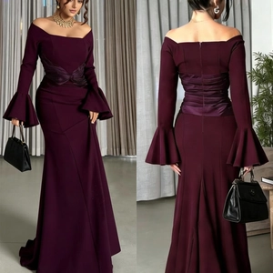 Close-up of off-shoulder evening dress with mermaid hem and pleated satin waist detail