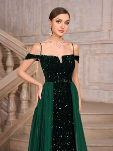 Detail of emerald green sequins on formal gown with thin straps and off-shoulder design