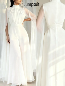 Detailed view of elegant white jumpsuit with high-neck pleats and chiffon cape sleeves