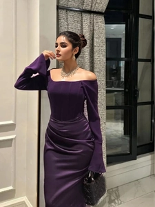 Elegant deep purple off-shoulder evening gown with long sleeves and pleated slit detail