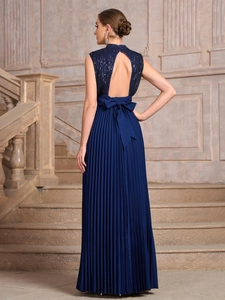 Detail of elegant backless design with a large bow on navy blue sequined evening gown