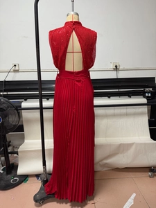Detail view of the red sequin high-neck top with an open triangular back design