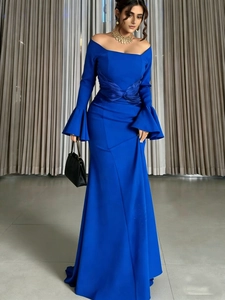 Detail of royal blue off-shoulder evening dress with bell sleeves and pleated bow accent