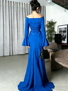 Detail of elegant royal blue off-shoulder mermaid dress showing slim fit and flared sleeves