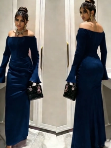 Detail of elegant dark blue off-shoulder satin gown with slim waist pleats and long sleeves