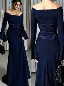 Detail view of navy off-shoulder dress featuring bell sleeves and ruched waist design