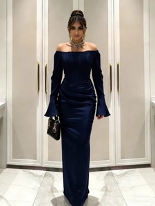 Detailed view of the midnight blue satin evening gown featuring elegant flared cuffs