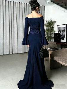 Rear view detail of a navy off-shoulder mermaid dress with ruffled back and flare sleeves