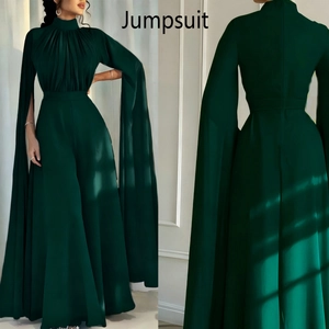 Front and back view of dark green jumpsuit with cape sleeves and pleated high neck