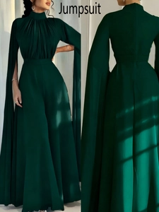 Front and back detail of dark green high neck jumpsuit with dramatic cape sleeves