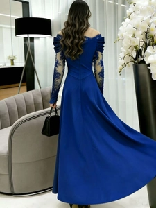 Rear view of an elegant floor-length evening gown with lace sleeves and satin fabric