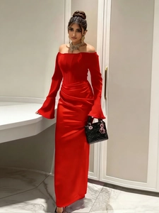 Detailed view of red satin off-shoulder evening gown with elegant flared sleeves and waist pleats