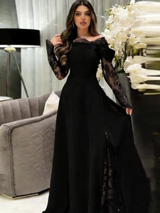 Close-up of elegant black off-shoulder lace neckline and translucent long floral sleeves