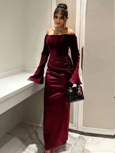 Detail of burgundy velvet dress featuring elegant off-shoulder neckline and side ruching