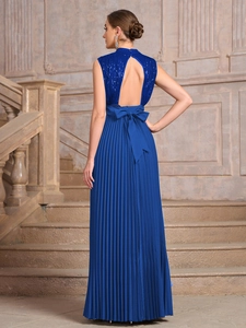 Detail of sequined backless dress featuring a large navy blue bow and pleated chiffon skirt