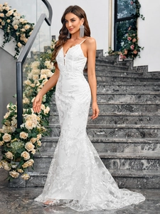 Elegant white lace mermaid wedding dress with spaghetti straps and floral embroidery