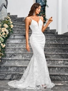 Detail of white fisheye wedding dress with floral lace embroidery and sheer V-neckline