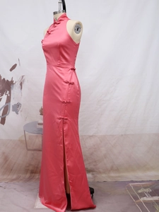 Detail of pink satin cheongsam dress featuring traditional frog buttons and side slit