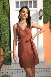 Detail of rust red wrap dress featuring V-neck and metal ring strap decoration