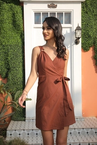 Detail of red-brown sleeveless wrap dress with V-neck and metal ring strap ornaments