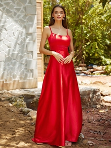Detail of red satin evening gown with spaghetti straps and floor-length A-line skirt