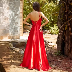 Elegant red backless satin evening gown with cross strap design and flowing maxi skirt