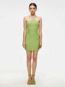 Detail of avocado green halter dress featuring textured pleats and bodycon slim fit design