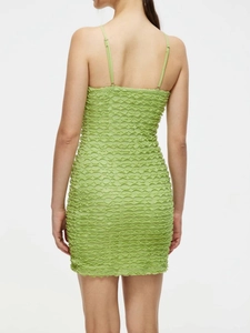 Detail of green ruched dress with spaghetti straps and bodycon fit from back view
