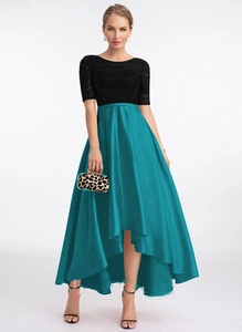 Detail of elegant black lace bodice and emerald green satin high-low hemline evening dress